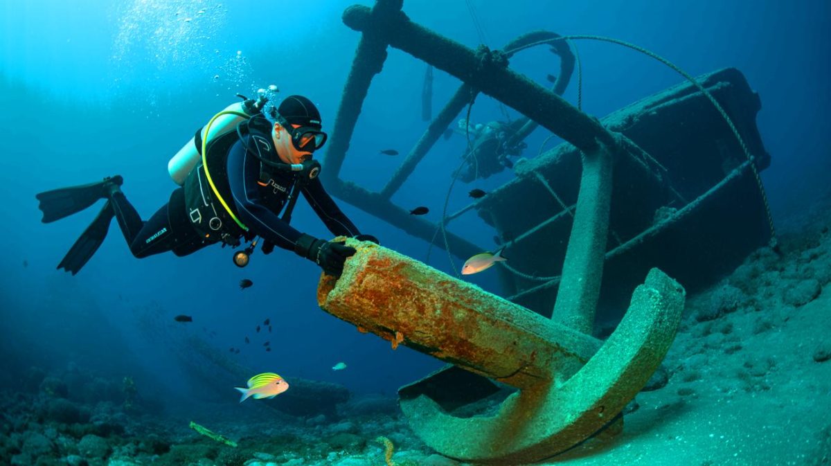 Illustration of divers uncovering a remarkably intact 2,500-year-old shipwreck off the coast of Sicily.